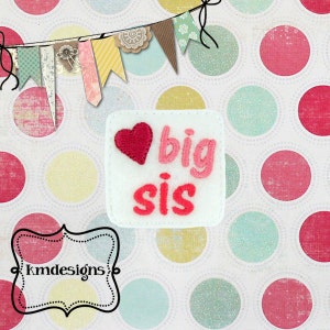 May include: White felt patch with pink and red embroidery. The patch says "big sis" with a pink heart.
