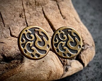 May include: A pair of gold-toned earrings with a black and gold swirl design.