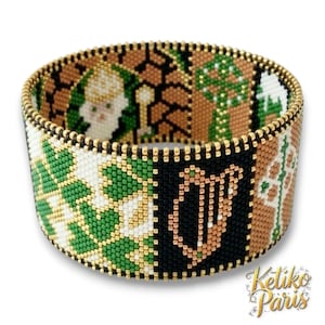 May include: A beaded bracelet with a gold-coloured trim. The bracelet features a repeating pattern of green, white, black, and brown beads. The design includes a harp, a shamrock, and a figure with a staff. The bracelet is approximately 5 cm wide.