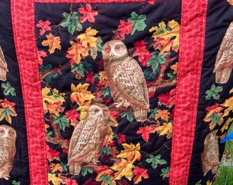 handmade quilt with owls and autumn leaves, quilted onto rich green matching polyester fleece, autumn colours, owls and fox, practical gift