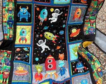handmade quilt, space theme and robots quilted onto a gold textured polyester fleece,  great gift for a child's room or space themed nursery