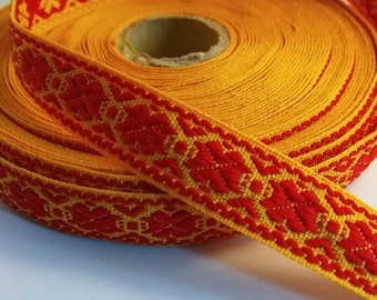 Ribbon with Latvian traditional ethnographic Zalktis signs yellow orange