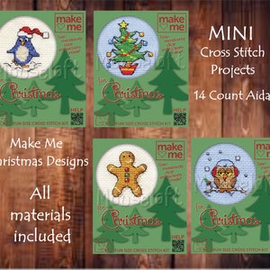 May include: Four mini cross stitch kits with a green background and a white circle in the centre. The kits feature a penguin, a Christmas tree, a gingerbread man, and an owl. The text "Make Me Christmas Designs" is at the top of the image. The text "All materials included" is at the bottom of the image.