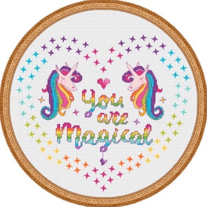 May include: A white embroidery hoop featuring a rainbow unicorn design and the text "You are Magical". The background is filled with small stars in various colours.