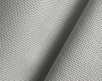 May include: Close-up of a white fabric with a textured weave. The fabric is folded in half, showing the texture on both sides.