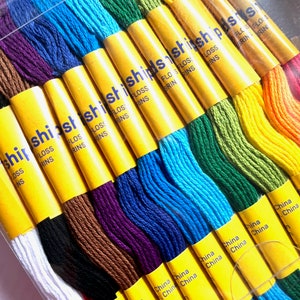 May include: A set of 12 embroidery floss spools in various colors, including white, red, brown, purple, blue, green, yellow, and orange. The spools are labeled "shishishishishids shish" and "China".