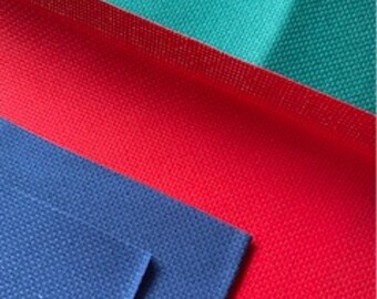 May include: Three fabric swatches in different colors: a dark blue, a red, and a teal green. The fabric has a textured woven pattern.