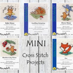 May include: A set of five mini cross stitch kits featuring adorable mouse designs. The kits include a ballet mouse, a snuffling hedgehog, a flower mouse, a blackberrying mouse, and a fox. Each kit contains Aida fabric, embroidery threads, a needle, and full charted instructions. The kits are labelled "Mouseloft" and feature the company's logo.