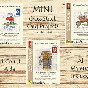 May include: Three cross stitch card project kits with a wooden background. Each kit includes a card and envelope. The first kit features a house with the text "Welcome to your new home". The second kit features a wheelbarrow with flowers and the text "Happy Retirement". The third kit features a teddy bear wearing a graduation cap and gown with the text "For special occasions".