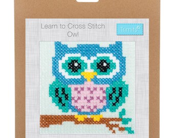 May include: A cross stitch kit featuring a blue, green, pink, and yellow owl on a branch. The kit includes instructions and all the materials needed to complete the project. The packaging says "Learn to Cross Stitch Owl" and "Trimits".