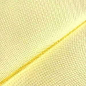 May include: A close-up of a pale yellow fabric with a fine weave. The fabric is folded in half, and the fold is visible as a thin, darker yellow line.