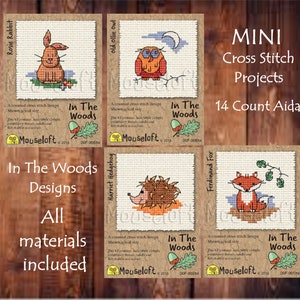 May include: Five mini cross stitch patterns featuring woodland animals, including a rabbit, owl, hedgehog, and fox. Each pattern is labeled "In The Woods" and includes the text "Mouseloft 2013" and a unique design code. The patterns are designed for 14 count Aida fabric.