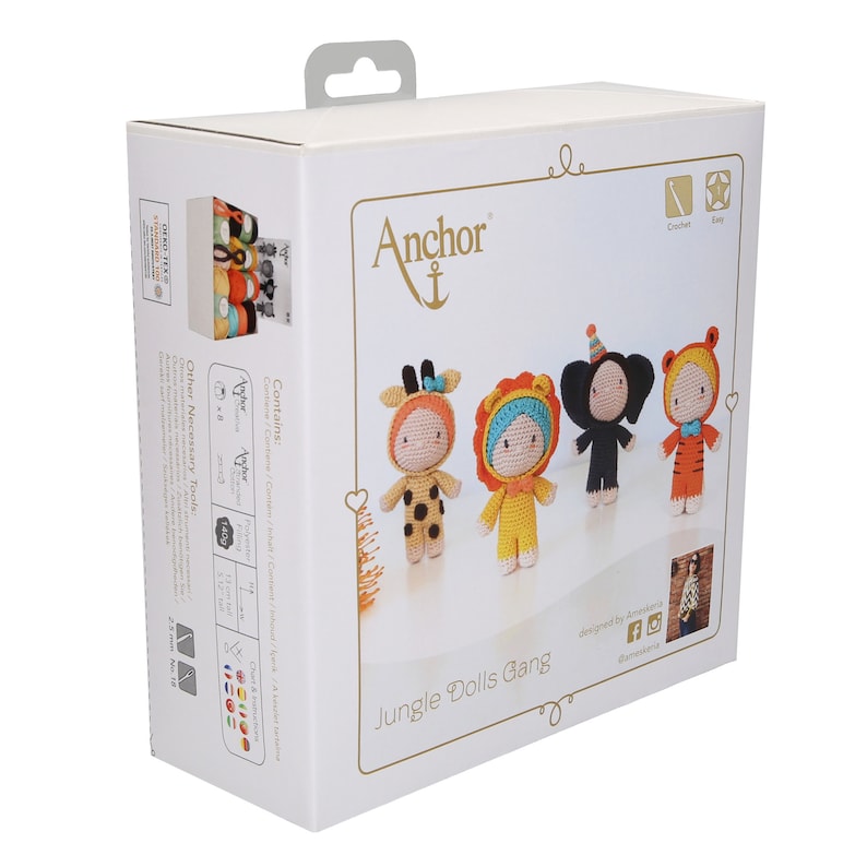 May include: A box for a crochet kit featuring four amigurumi jungle animal dolls. The dolls are a giraffe, lion, elephant, and tiger. The box is white with gold accents and the text "Jungle Dolls Gang" on the front.
