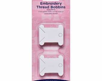 May include: A package of 50 white paper embroidery thread bobbins. The package is pink and blue and says "Embroidery Thread Bobbins Easy-Wind" and "Hemline".