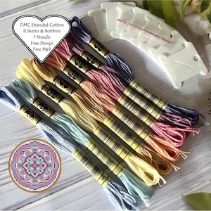 May include: A set of eight skeins of DMC stranded cotton embroidery floss in a rainbow of colours, including light blue, lavender, pink, peach, yellow, and cream. The floss is packaged with bobbins and a needle. The image also includes a small, circular cross-stitch pattern with a mandala design. The text on the packaging reads "DMC Stranded Cotton 8 Skeins & Bobbins 1 Needle Free Design Free P&P".