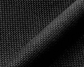 May include: Close-up of a black fabric with a textured weave. The fabric has a subtle sheen and a slightly rough feel.