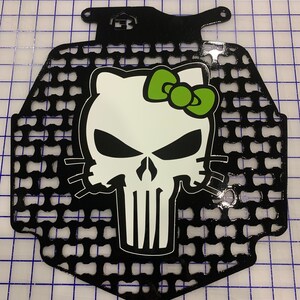 May include: Black metal motorcycle radiator guard with a white and green Hello Kitty skull graphic.