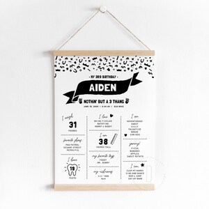 May include: Black and white printable birthday chart for a 3-year-old boy named Aiden. The chart includes details like his weight (31 pounds), height (38 inches), favorite things, and skills. The text "Nothin' but a 3 thang" is featured at the top.