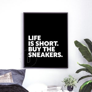 May include: Black and white typography print with the text "Life is short. Buy the sneakers."