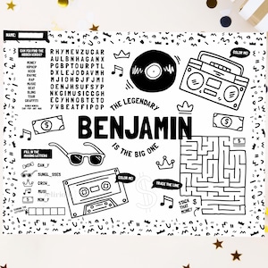 May include: A black and white activity placemat featuring the name Benjamin, a word search, a maze, and illustrations of a boombox, cassette tape, vinyl record, sunglasses, crowns, and dollar bills with the text The Legendary Benjamin Is The Big One.