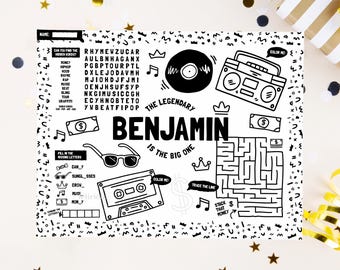 May include: A black and white activity placemat featuring the name Benjamin, a word search, a maze, and illustrations of a boombox, cassette tape, vinyl record, sunglasses, crowns, and dollar bills with the text The Legendary Benjamin Is The Big One.