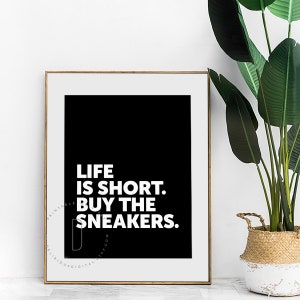 May include: Black and white printable wall art with the text "Life is short. Buy the sneakers."