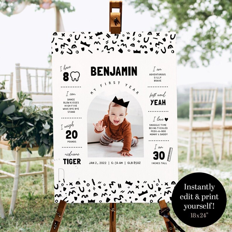May include: A black and white first birthday milestone poster with a photo of a baby boy. The poster includes the baby's name, Benjamin, and details about his first year, including his weight, height, and first words. The poster is decorated with a black and white geometric pattern.