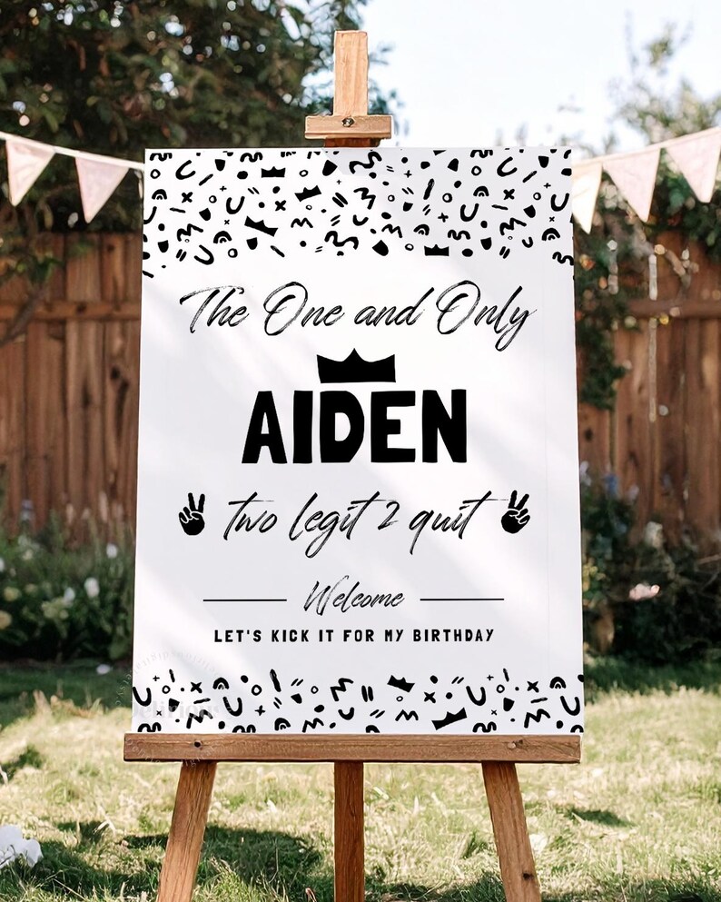 May include: A white rectangular birthday welcome sign featuring black text and abstract patterns. The sign reads: The One and Only AIDEN, two legit 2 quit, Welcome, and LET'S KICK IT FOR MY BIRTHDAY. It includes a crown icon and two peace sign hand icons.