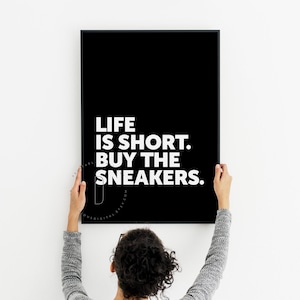 May include: Black and white printable wall art with the text "Life is short. Buy the sneakers."