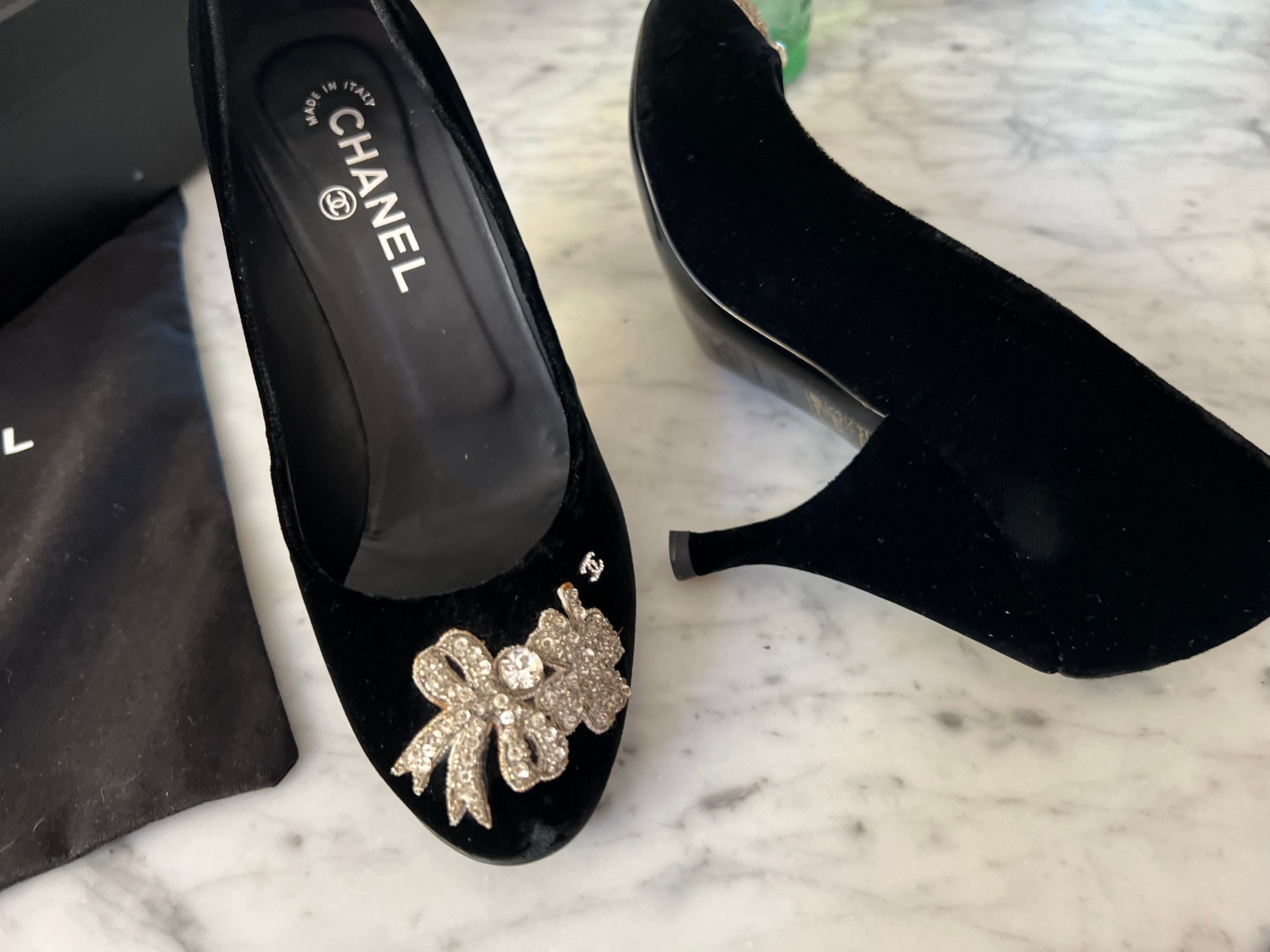 Chanel black velvet pumps with rhinestone and sequin bow.