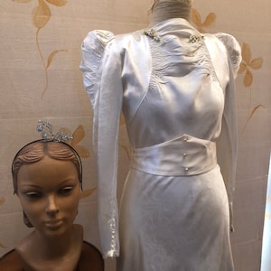 1930s silk satin brocade bride gown with wax flower decoration.