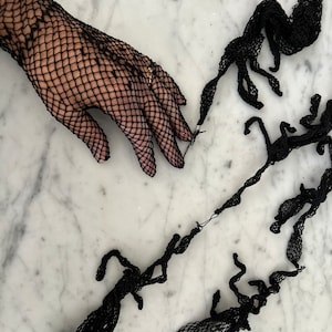 Vintage black fishnet lace gloves. Old store stock.