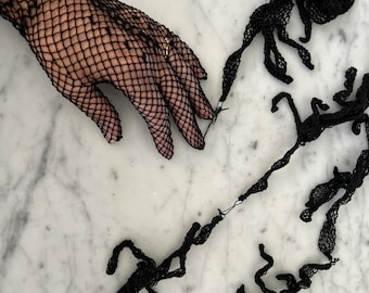 Vintage black fishnet lace gloves. Old store stock.