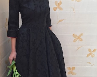 1950s black fit and flare embroidered taffeta cocktail dress with red piping