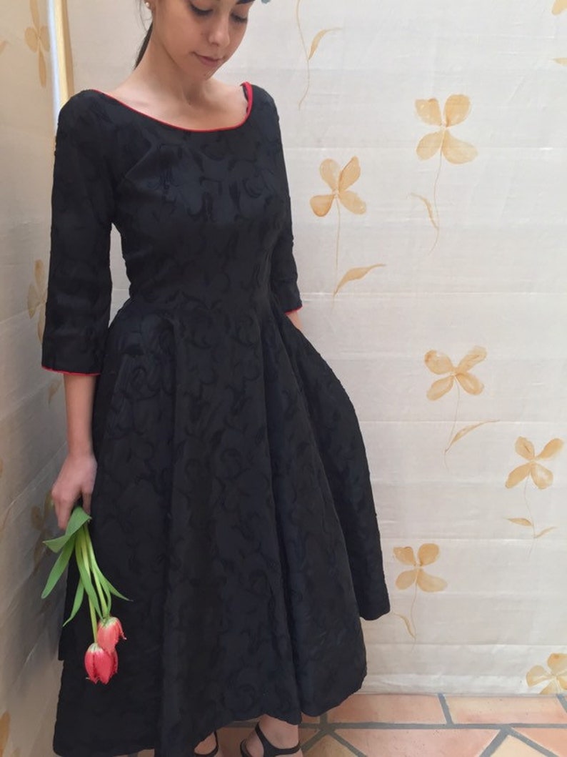 1950s black fit and flare embroidered taffeta cocktail dress with red piping