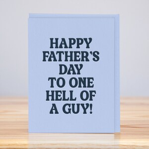 May include: A light blue card with the text "Happy Father's Day to one hell of a guy!" in dark blue.