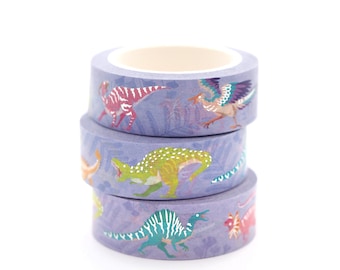 May include: Three rolls of purple washi tape with dinosaur and bird illustrations. The tape is decorated with a pale purple background and a white pattern.