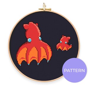 May include: Cross stitch pattern featuring two red octopuses on a dark blue background. The larger octopus is in the foreground and the smaller octopus is in the background. The pattern is labeled "PATTERN" in a purple circle.