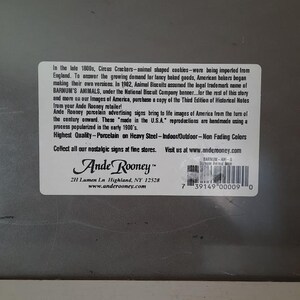 May include: A rectangular sticker with text about Ande Rooney porcelain advertising signs. The sticker includes the text "Highest Quality - Porcelain on Heavy Steel - Indoor/Outdoor - Non Fading Colors."
