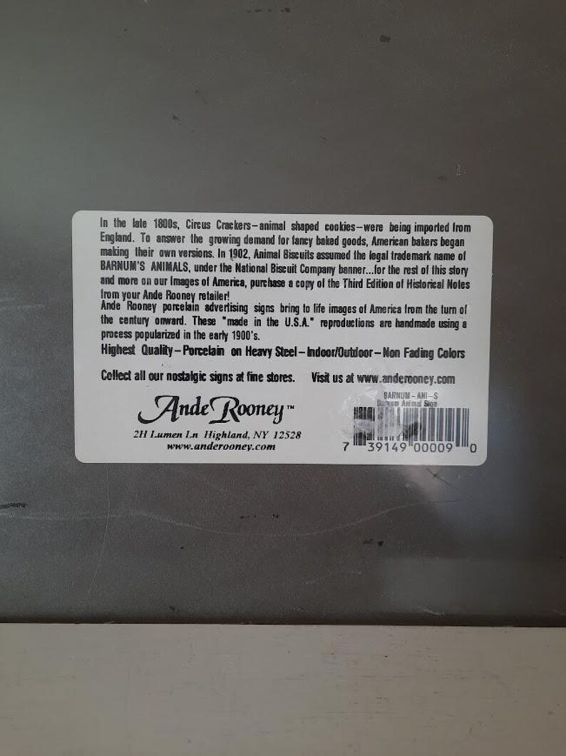 May include: A rectangular sticker with text about Ande Rooney porcelain advertising signs. The sticker includes the text "Highest Quality - Porcelain on Heavy Steel - Indoor/Outdoor - Non Fading Colors."