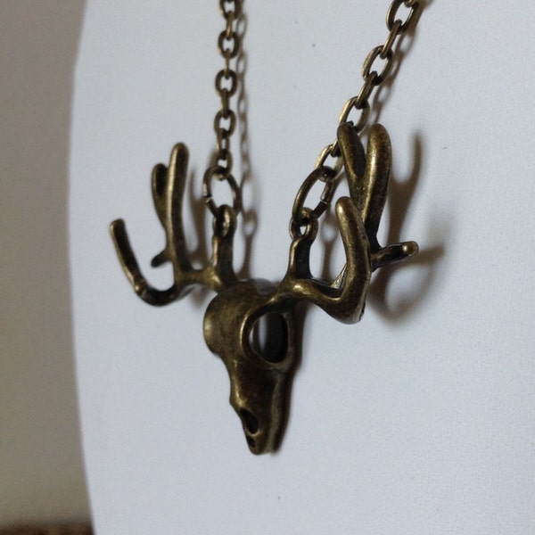 Amazing and unique brass Moose/Deer Head Skull suspended from a delicate brass chain.