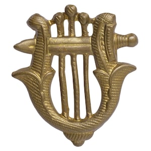 May include: A gold-colored metal harp with a detailed design. The harp is a decorative object with a traditional design.