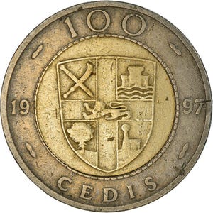 May include: A gold and silver coin featuring a detailed coat of arms at the center. The coin has the number "100" at the top, the year "1997" on the right, and the word "CEDIS" at the bottom. The coin's design includes a shield with various symbols.