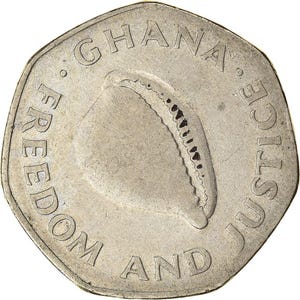May include: A silver coin with the words "GHANA", "FREEDOM AND JUSTICE" around the edge. The coin features a central design of a shell-like shape with a dotted pattern. The coin has a heptagonal shape.