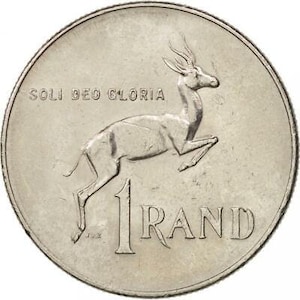 以下が含まれることがあります： 南アフリカの1ランド銀貨。スプリングボックの羚羊と「SOLI DEO GLORIA」の文字が刻まれています。