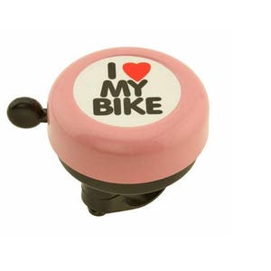 May include: Pink bicycle bell with the text "I ❤️ MY BIKE" in black letters and a red heart on a white background. The bell has a black lever and a black mounting bracket.