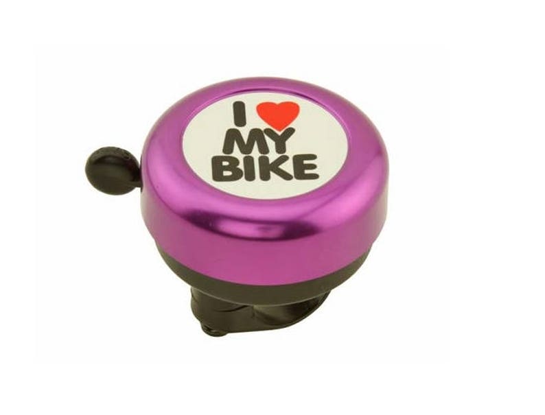 May include: A purple bicycle bell with the text "I ❤️ MY BIKE" in black letters and a red heart on a white background. The bell has a black lever and a black base, designed to attach to a bicycle handlebar.