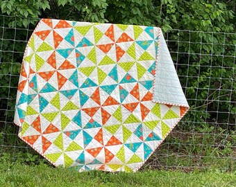 Handmade pinwheel lap or throw quilt, bright teal, orange, chartreuse green, and cream. Available now for shipping