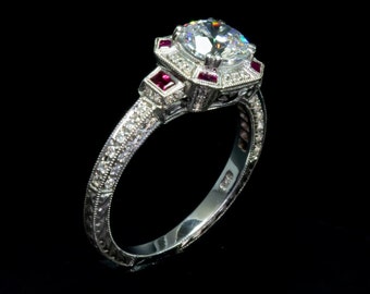 May include: A silver engagement ring with a large, round, clear diamond center stone. The ring has a decorative band with small diamonds and four red ruby accents.