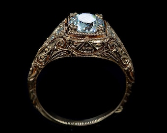 May include: A gold ring with a large, clear diamond set in a filigree design.